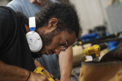 Broadway Camp production students use a drill to attach straps to prop guns for Les Miserables at Proctors Thursday, July 15, 2019.