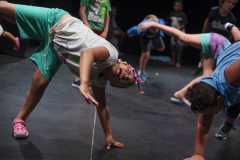 Students from Acting Out! do yoga with their teacher before rehearsing their skits in the Addy theatre Thursday, July 18, 2019.