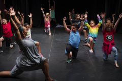 Students from Acting Out! do yoga with their teacher before rehearsing their skits in the Addy theatre Thursday, July 18, 2019.
