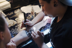 Students in Creating Effects: Advanced Makeup Techniques learn how to paint and draw on fake tattoos in the dressing rooms at Proctors Thursday, July 25, 2019.